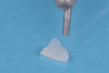 (18.) The fractured composite fragment after sandblasting as a surface treatment, followed by etching and application of a single layer of silane, prepared for reattachment.
